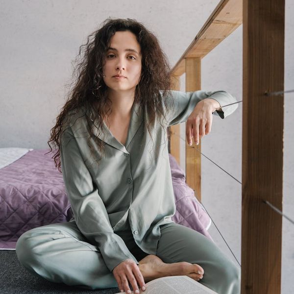 Person meditating peacefully with soft lighting.